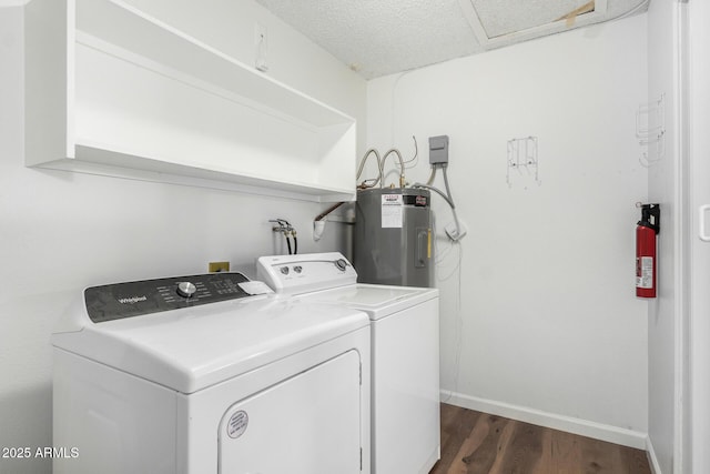 laundry area with washing machine and clothes dryer, dark wood-style flooring, baseboards, laundry area, and water heater