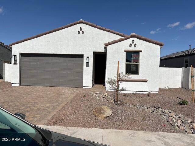 18126 W Hiddenview Dr, Goodyear, AZ 85395 - view of front of property with a garage, a tiled roof, decorative driveway, and stucco siding
