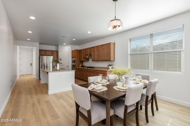 dining space featuring light hardwood / wood-style flooring