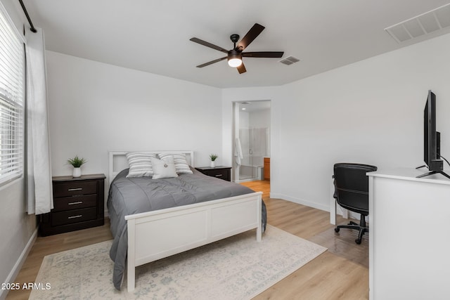 bedroom with ceiling fan, ensuite bath, and light hardwood / wood-style flooring