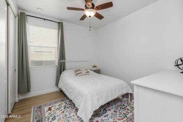 bedroom featuring light hardwood / wood-style flooring, a closet, and ceiling fan