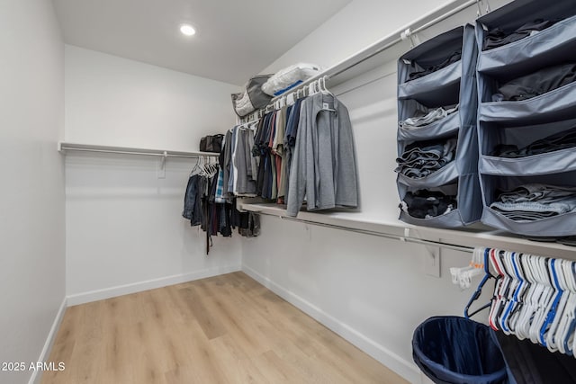 walk in closet featuring light hardwood / wood-style flooring