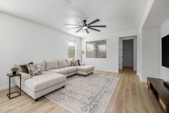 living room featuring ceiling fan and light wood-type flooring