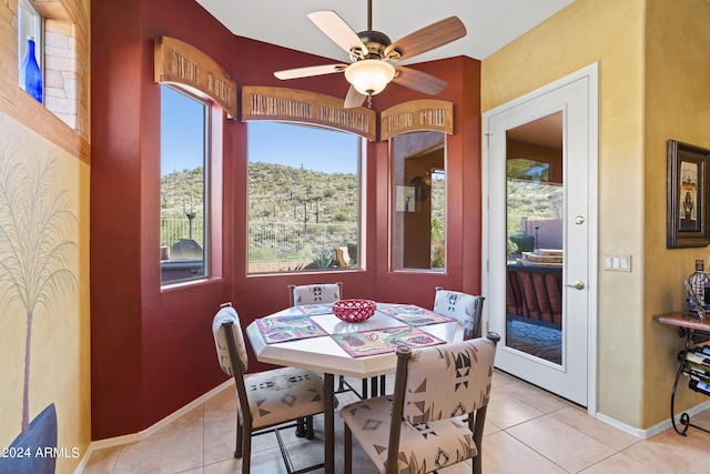 tiled dining room featuring ceiling fan