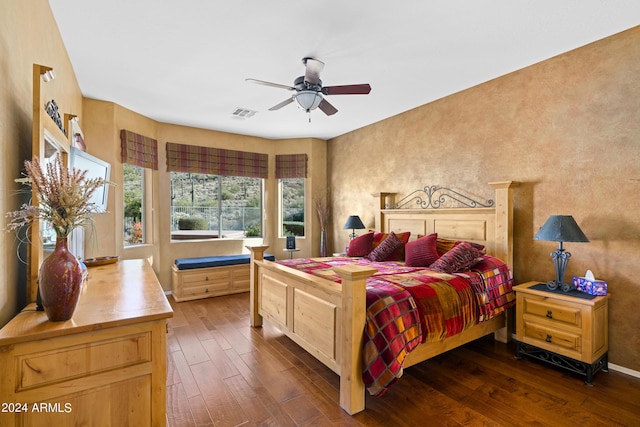 bedroom with ceiling fan and dark hardwood / wood-style flooring