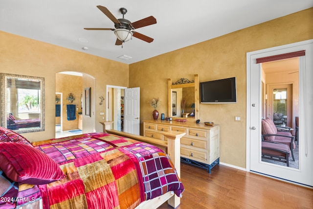 bedroom featuring multiple windows, ceiling fan, and dark hardwood / wood-style flooring