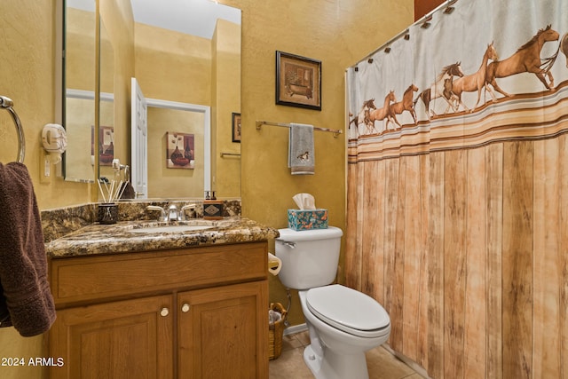 bathroom featuring tile patterned flooring, vanity, and toilet