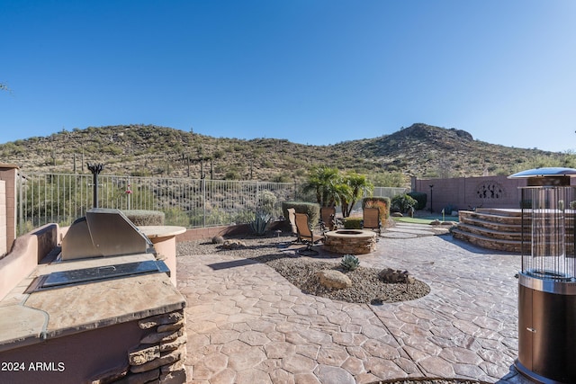 view of patio / terrace with area for grilling and a mountain view