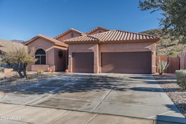 mediterranean / spanish-style home featuring a garage