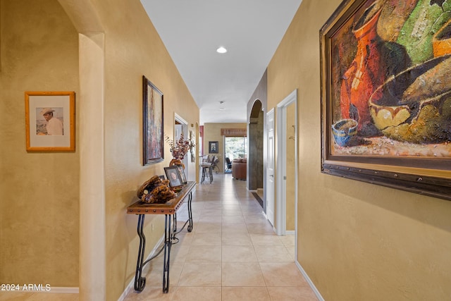 hall with light tile patterned floors