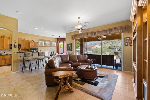 living room featuring ceiling fan and light tile patterned flooring