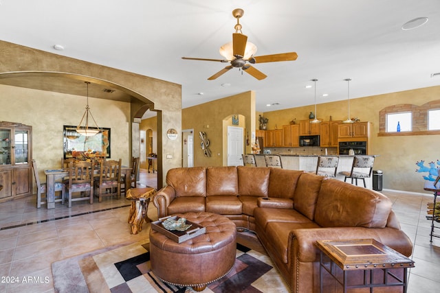 tiled living room with ceiling fan