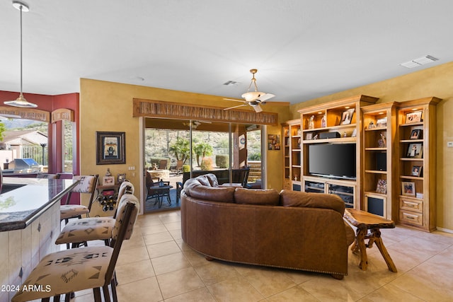 living room with ceiling fan and light tile patterned floors