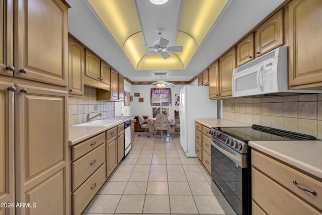 kitchen featuring white appliances, sink, ceiling fan, light tile patterned floors, and tasteful backsplash