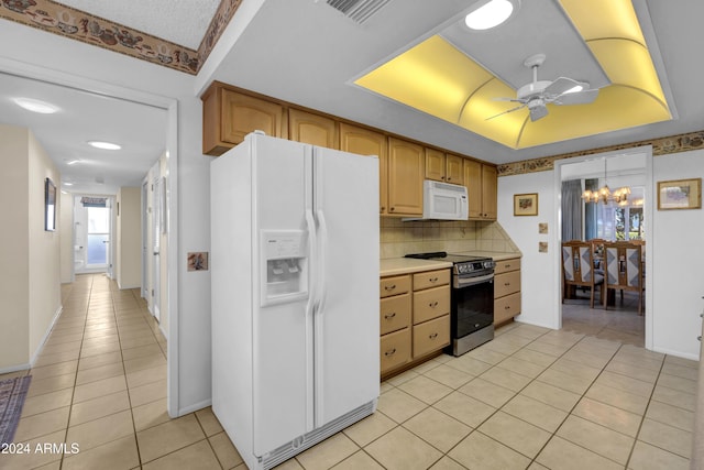 kitchen featuring tasteful backsplash, white appliances, light brown cabinetry, light tile patterned floors, and ceiling fan with notable chandelier