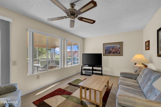 tiled living room featuring ceiling fan and a textured ceiling