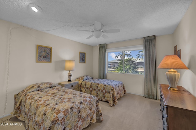 bedroom with light carpet, a textured ceiling, and ceiling fan