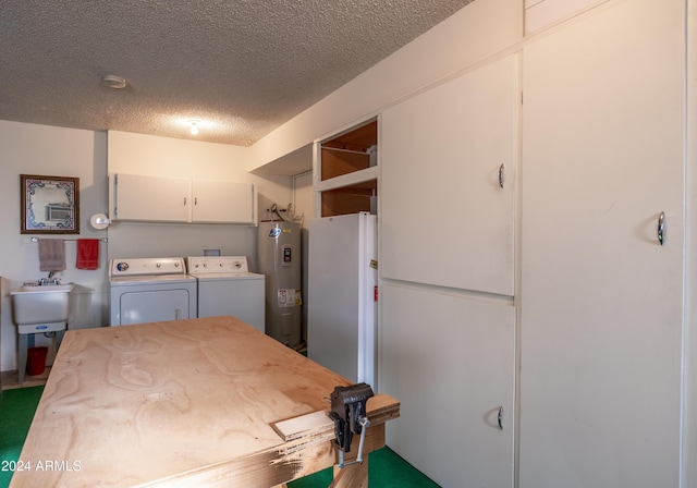 interior space featuring sink, cabinets, electric water heater, independent washer and dryer, and a textured ceiling