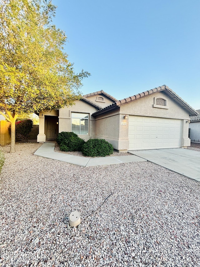 22951 W Loma Linda Blvd, Buckeye, AZ 85326 - view of front of house with an attached garage, stucco siding, concrete driveway, and a tile roof