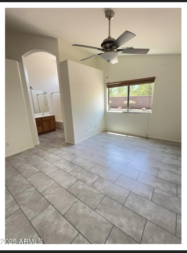 22951 W Loma Linda Blvd, Buckeye, AZ 85326 - spare room with arched walkways, a ceiling fan, and light tile patterned flooring