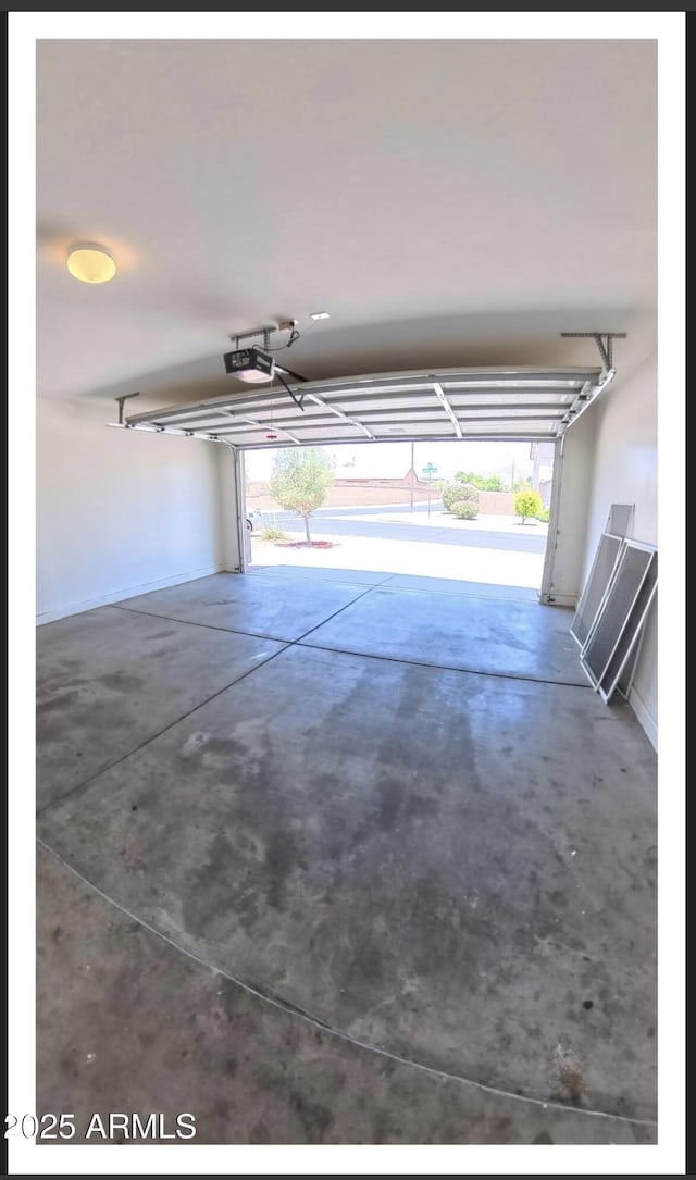 22951 W Loma Linda Blvd, Buckeye, AZ 85326 - garage featuring a garage door opener and baseboards