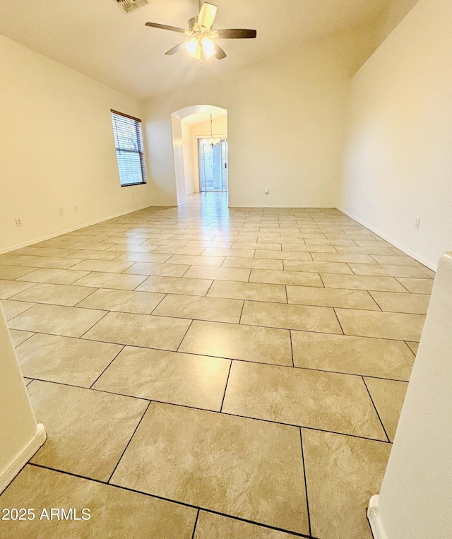 22951 W Loma Linda Blvd, Buckeye, AZ 85326 - spare room featuring a ceiling fan, arched walkways, light tile patterned floors, and vaulted ceiling
