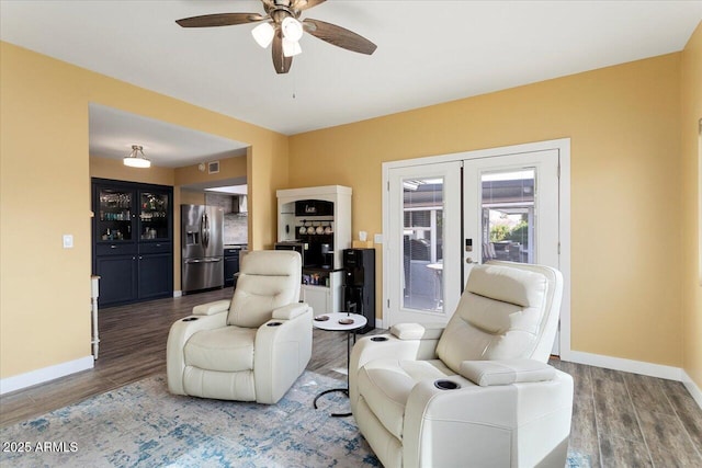 living room featuring hardwood / wood-style floors, ceiling fan, and french doors