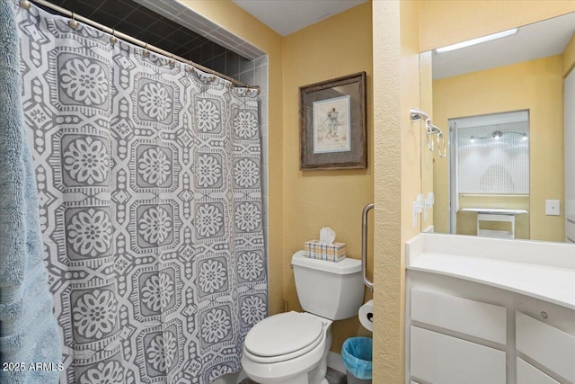 bathroom featuring vanity, toilet, and a shower with shower curtain