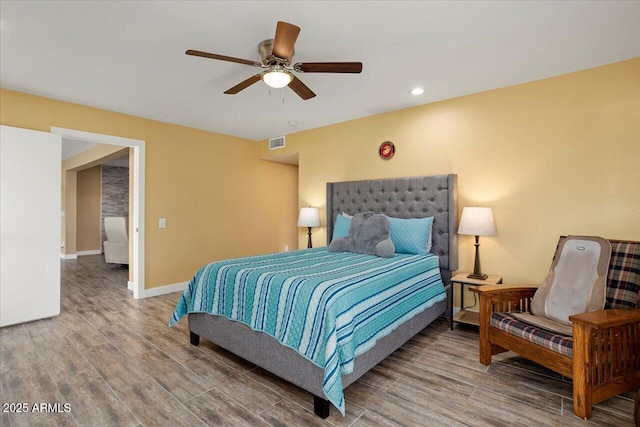 bedroom featuring hardwood / wood-style floors and ceiling fan