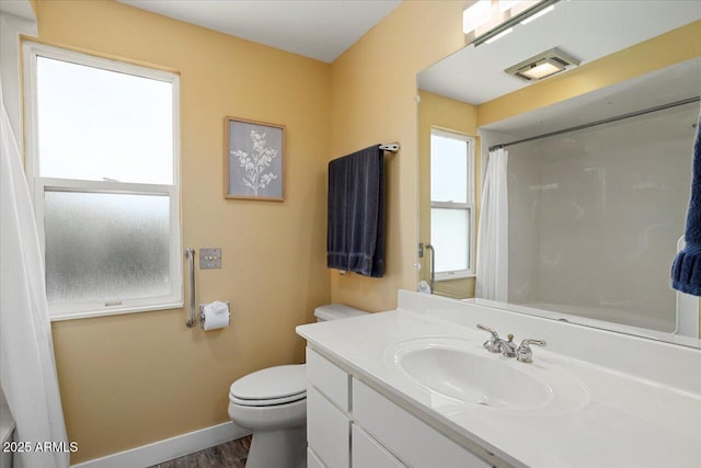 bathroom with hardwood / wood-style flooring, vanity, walk in shower, and toilet