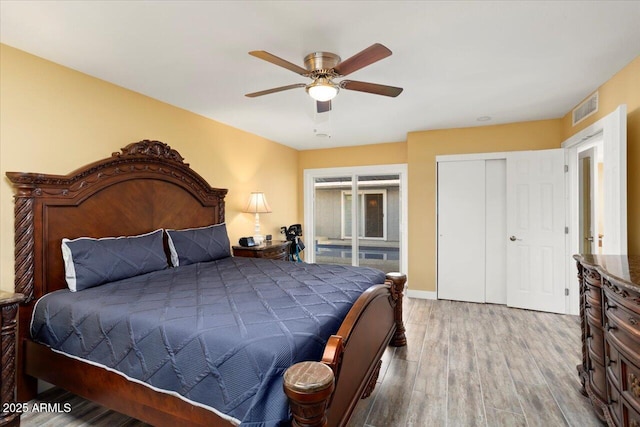 bedroom featuring hardwood / wood-style flooring, a closet, and ceiling fan