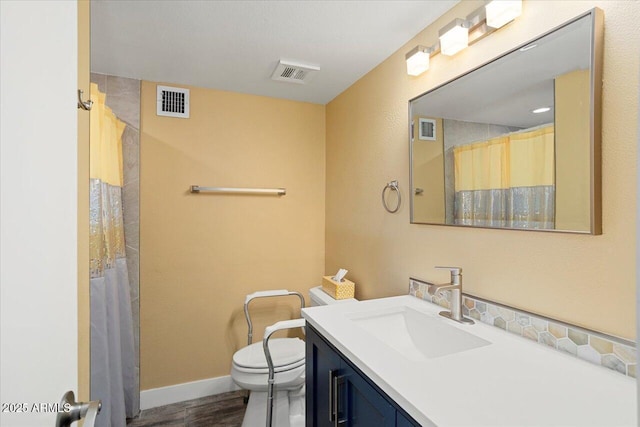 bathroom featuring vanity, hardwood / wood-style flooring, a shower with curtain, and toilet