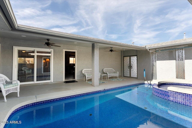 view of swimming pool with a patio, ceiling fan, and an in ground hot tub