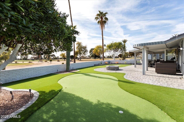 view of home's community with a patio and an outdoor living space with a fire pit