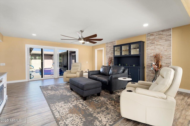 living room featuring dark hardwood / wood-style floors and ceiling fan