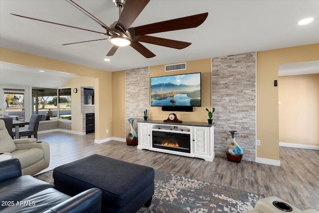 living room featuring hardwood / wood-style floors and ceiling fan