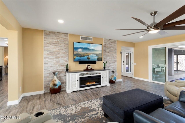 living room with ceiling fan and hardwood / wood-style floors