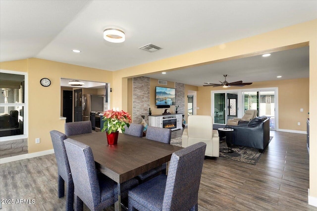 dining area featuring ceiling fan, wood-type flooring, and lofted ceiling