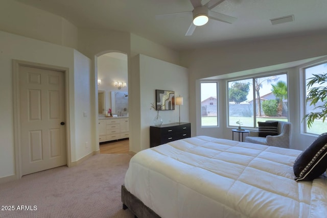 3940 E Heather Ct, Gilbert, AZ 85234 - bedroom featuring arched walkways, light carpet, ensuite bath, and a ceiling fan