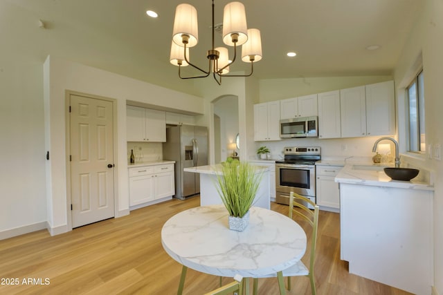 3940 E Heather Ct, Gilbert, AZ 85234 - dining space featuring arched walkways, a chandelier, vaulted ceiling, light wood-style flooring, and recessed lighting