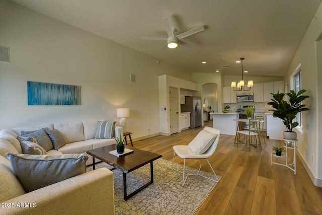 3940 E Heather Ct, Gilbert, AZ 85234 - living area with a ceiling fan, a chandelier, vaulted ceiling, light wood-style flooring, and recessed lighting