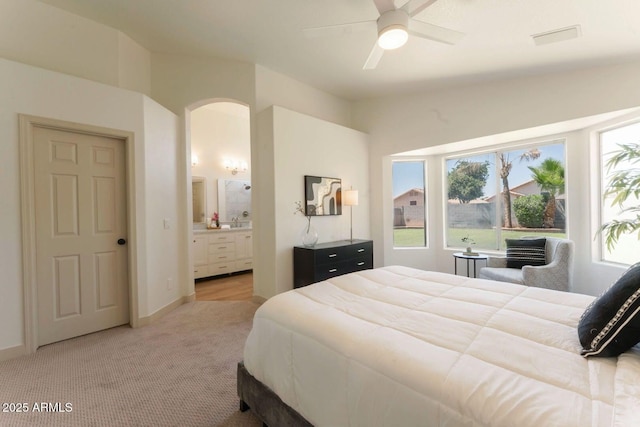 3940 E Heather Ct, Gilbert, AZ 85234 - bedroom with light carpet, arched walkways, ensuite bathroom, and ceiling fan