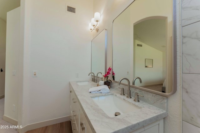 3940 E Heather Ct, Gilbert, AZ 85234 - full bathroom featuring double vanity, vaulted ceiling, and wood finished floors