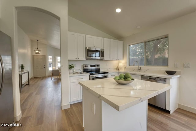 3940 E Heather Ct, Gilbert, AZ 85234 - kitchen with stainless steel appliances, lofted ceiling, light wood-style flooring, white cabinets, and recessed lighting