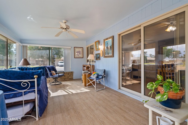 sunroom featuring ceiling fan