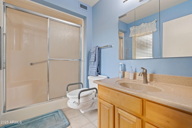 bathroom with toilet, vanity, tile patterned floors, and walk in shower