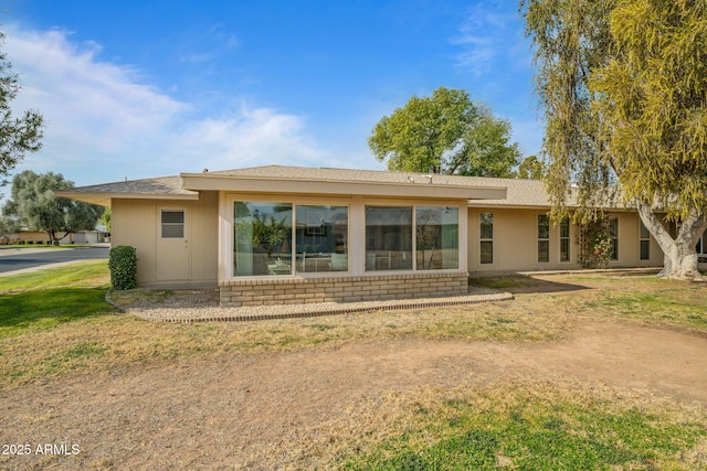 rear view of house with a lawn