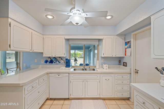 kitchen with light tile patterned flooring, sink, dishwasher, ceiling fan, and white cabinets