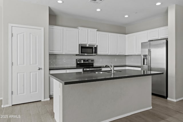 29302 N 126th Ln, Peoria, AZ 85383 - kitchen featuring appliances with stainless steel finishes, dark countertops, white cabinetry, and recessed lighting