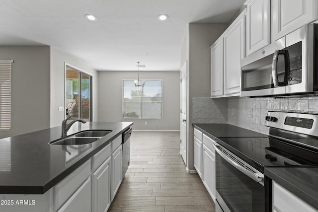 29302 N 126th Ln, Peoria, AZ 85383 - kitchen with appliances with stainless steel finishes, a sink, dark countertops, white cabinets, and recessed lighting